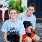 Brother campers with littermate puppies